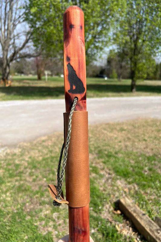 Handcrafted red cedar wood walking stick with engraved wolf, full leather grip, brass buttons, and paracord wrist strap, made in USA