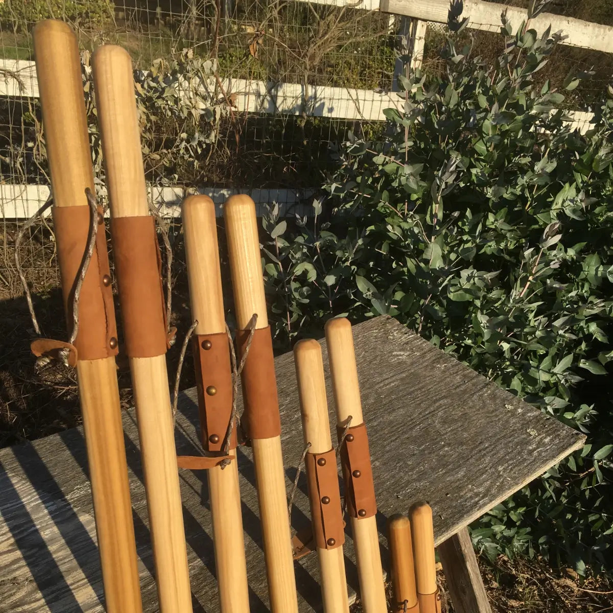 Handcrafted poplar walking sticks in multiple sizes with leather grips and paracord — natural earth tones hiking staff