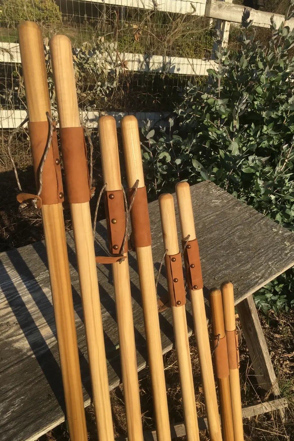 Handcrafted poplar walking sticks in multiple sizes with leather grips and paracord — natural earth tones hiking staff