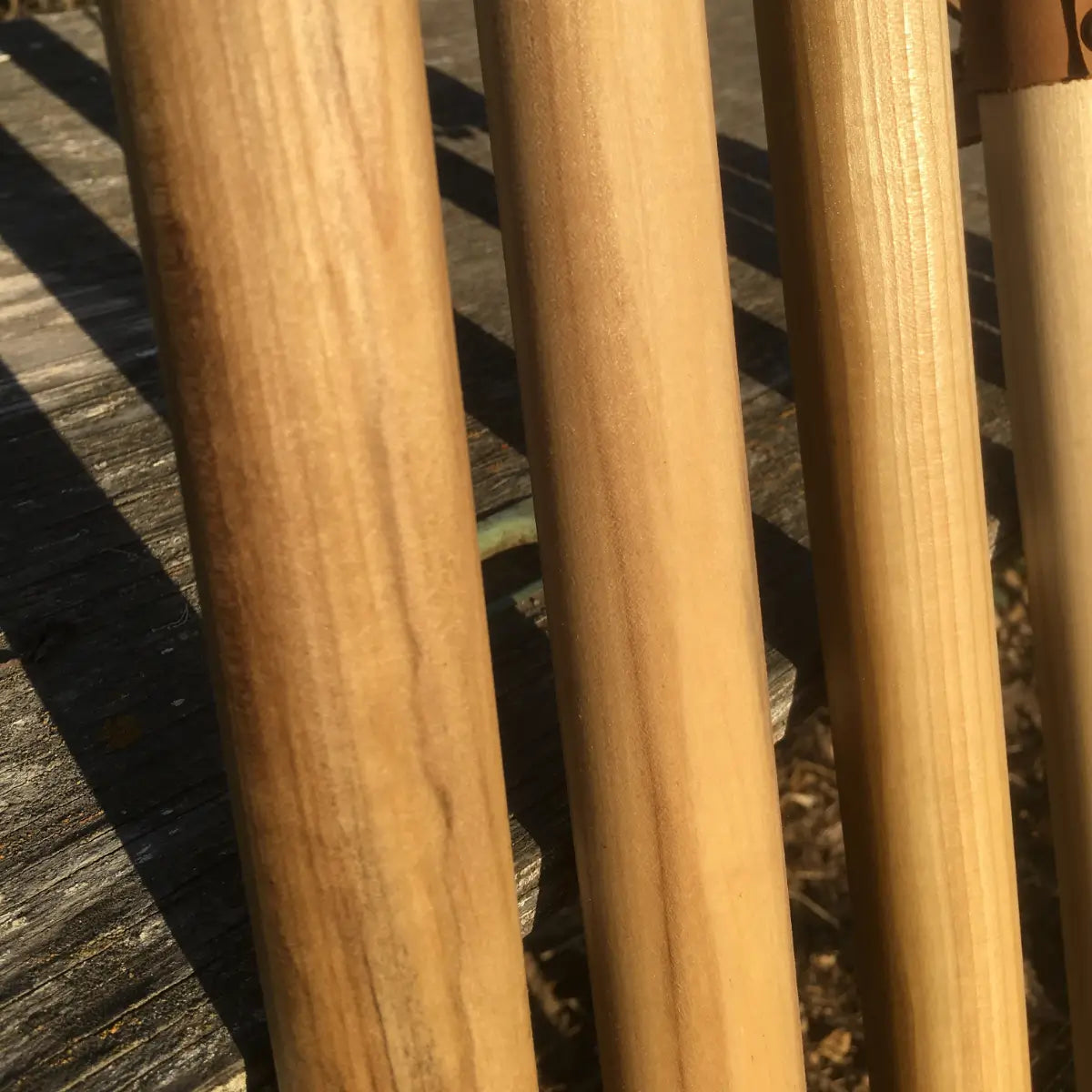 Close-up of A-grade poplar wood grain on handcrafted walking sticks — natural earth tones, made in USA