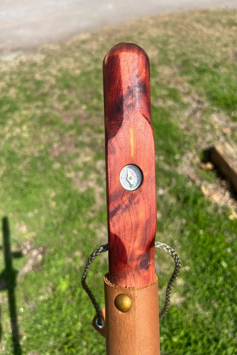 Close-up of inlaid 5/8" aluminum rustproof military compass on handcrafted cedar wood walking stick, made in USA