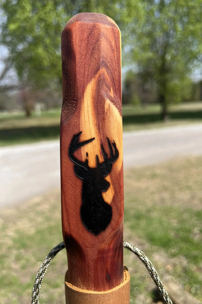 Close-up of engraved deer on handcrafted cedar wood walking stick, made in USA