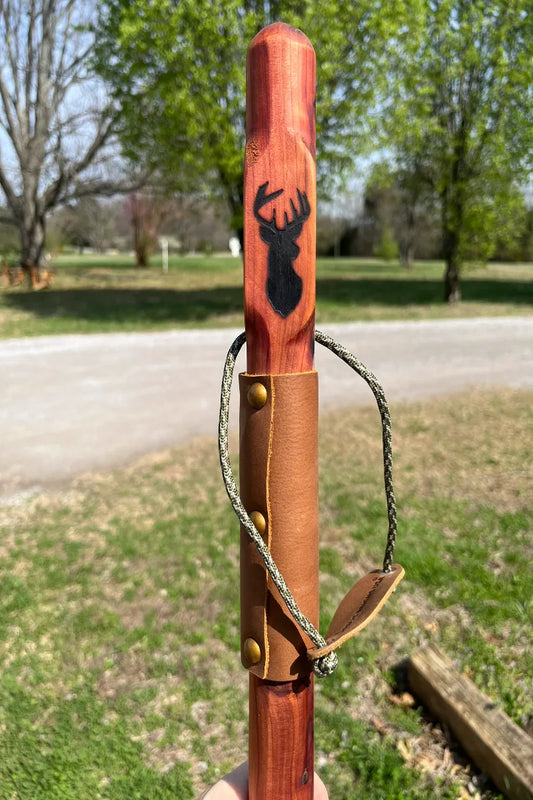 Handcrafted red cedar wood walking stick with engraved deer, full leather grip, brass buttons, and paracord wrist strap, made in USA