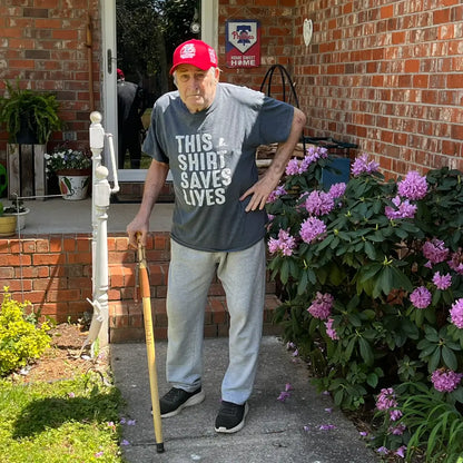 Elderly man using personalized Jesus and Sheep wood walking cane outdoors — Christian gift for seniors