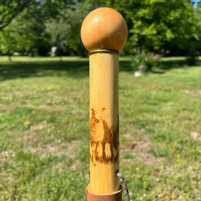 Sheep wood-burned carving close-up on upper shaft, ball handle above