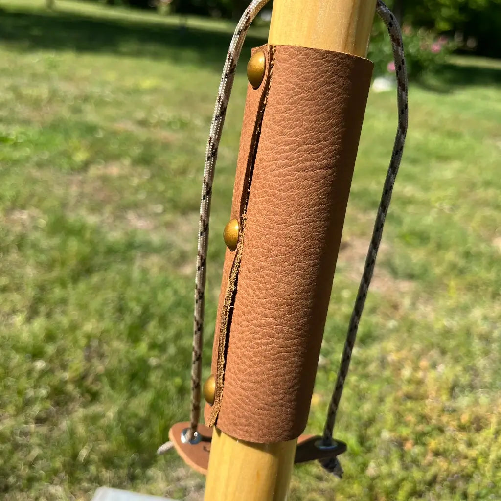 Leather wrist wrap grip with brass rivets and paracord wrist strap