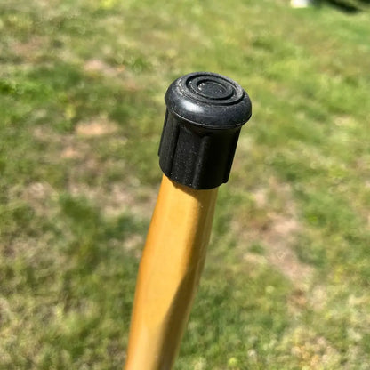 Close-up of non-slip rubber ferrule on Jesus and Sheep wood walking cane — safety grip detail