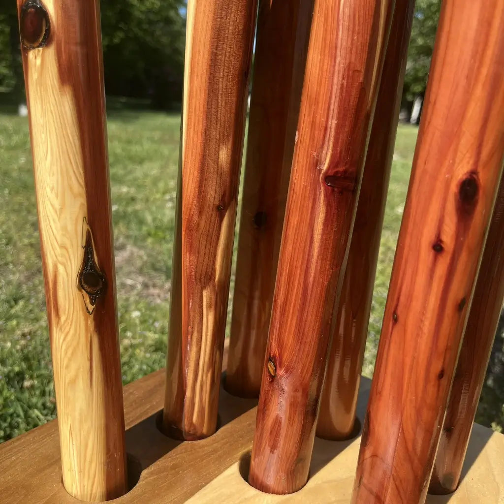 Natural color variation in handcrafted red cedar walking cane shafts — light to deep red grain
