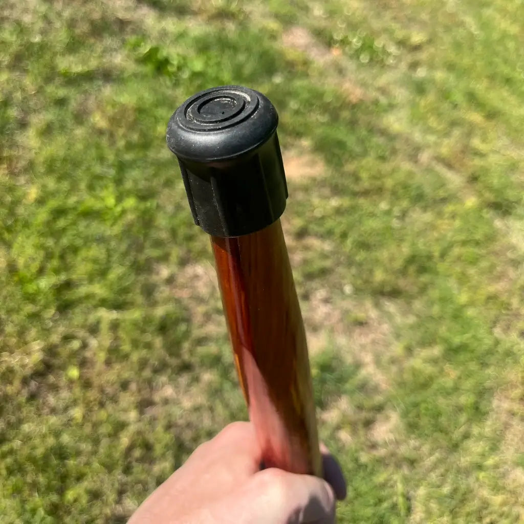 Black Rubber  Cane tip on Red Cedar cane shaft.  Held upside down shows the circular rubber non slip ridges on the Cane tip.